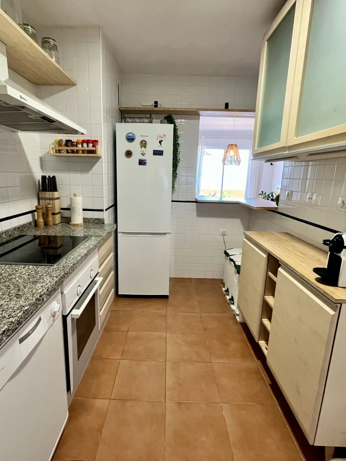 Existing kitchen with light cabinets and tiled walls shown on the LookHome projects page